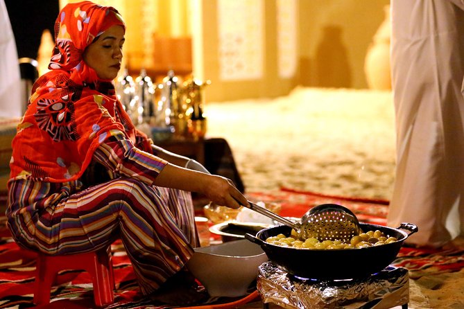 Abu Dhabi Afternoon Desert Safari and BBQ Dinner - Sandboarding and camel riding at the camp