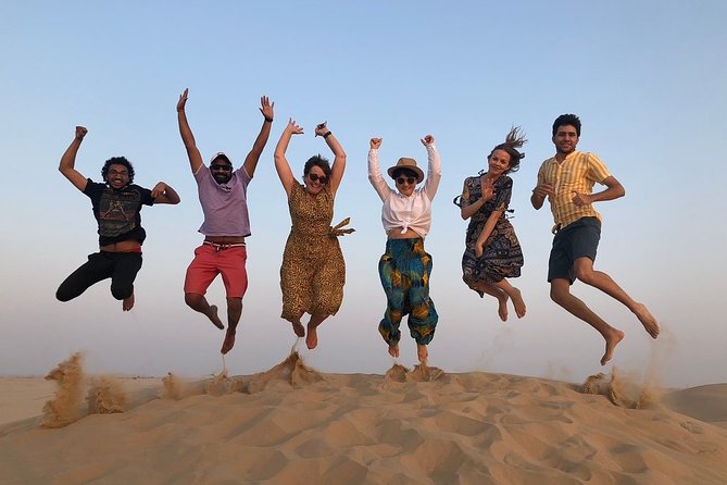 Abu Dhabi Desert Safari with BBQ Dinner & Shows - Sandboarding and the red dunes at sunset