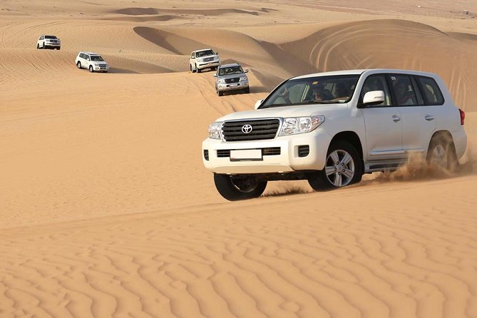 Best Dubai Desert Safari with Buffet Dinner,Sand Boarding & Shows - Dune bashing across Lahbab’s golden sand