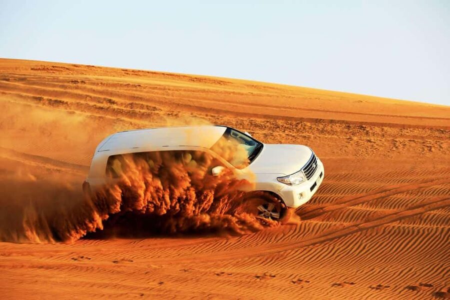 Desert Safari Dubai with Camel Ride, Sandboarding & Dinner - Taking the wheel on a quad bike