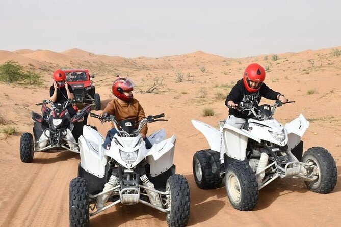 Desert Safari W/BBQ Dinner, Quad Bike, Camel Ride, & Sandboarding - Quad Biking Across the Sand