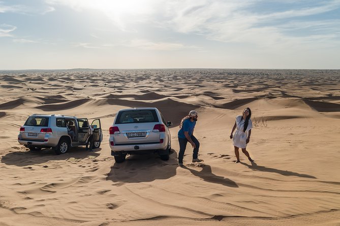 Dubai Desert Discovery: Red Dunes Safari, Sandboard & Camel Ride - Sandboarding on the golden slopes