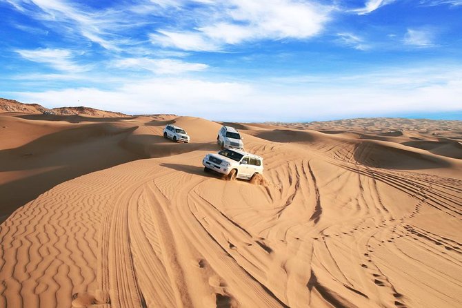 Dubai Desert Journey: Red Dunes Safari with BBQ in Bedouin Camp - Sandboarding and sunset at the highest dune