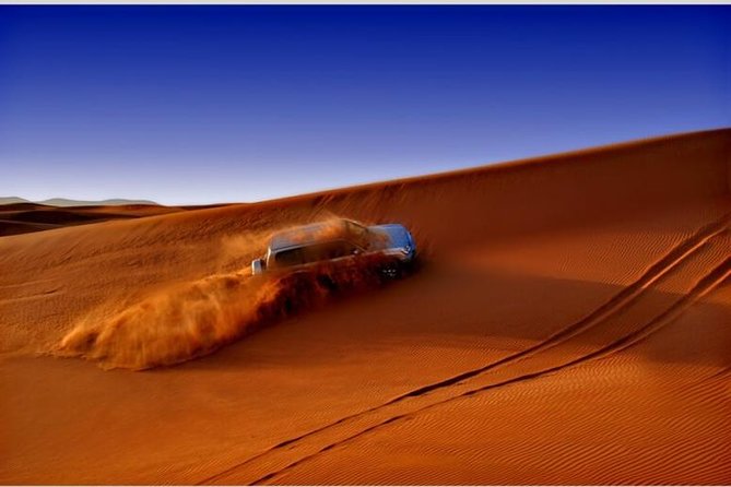 Dubai Desert Red Dune Half-Day Safari Adventure and BBQ Dinner - Tanoura, belly dance, and fire performances