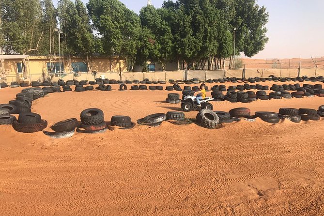 Dubai Desert Safari and Quad Bike Ride with Buffet Dinner - Quad biking in a fenced desert area