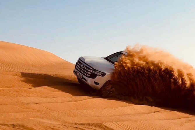 Dubai Desert Safari, Camel Ride, Entertainment Shows & BBQ Dinner - Sandboarding adds a quieter kind of fun