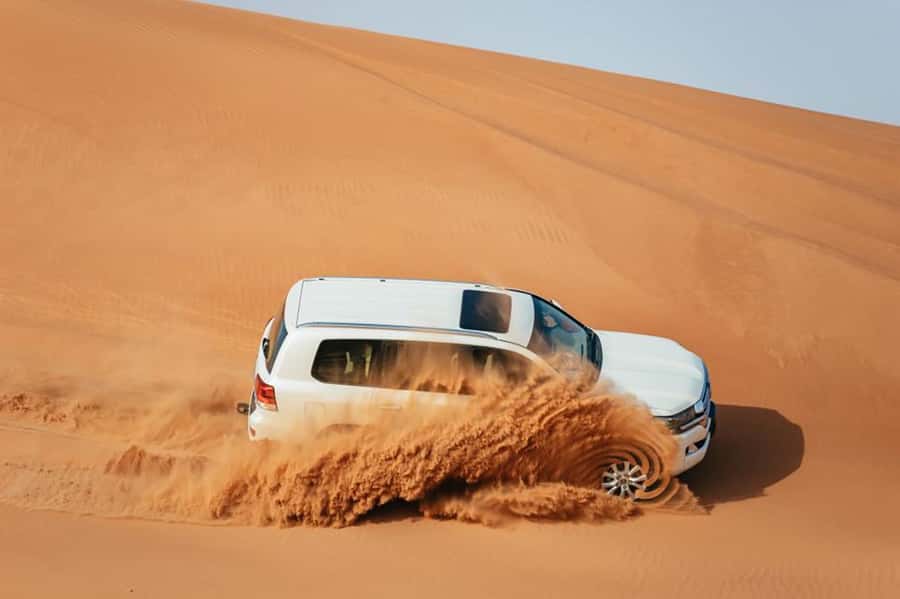 Dubai: Desert Safari, Camel Ride, Sandboarding, Quad Bike - Quad biking at Lahbab, with a serious safety warning