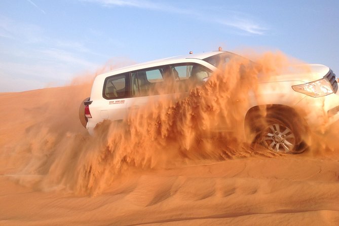 Dubai: Desert Safari, Camel Ride, Show & Optional Dinner - Sandboarding down a soft dune