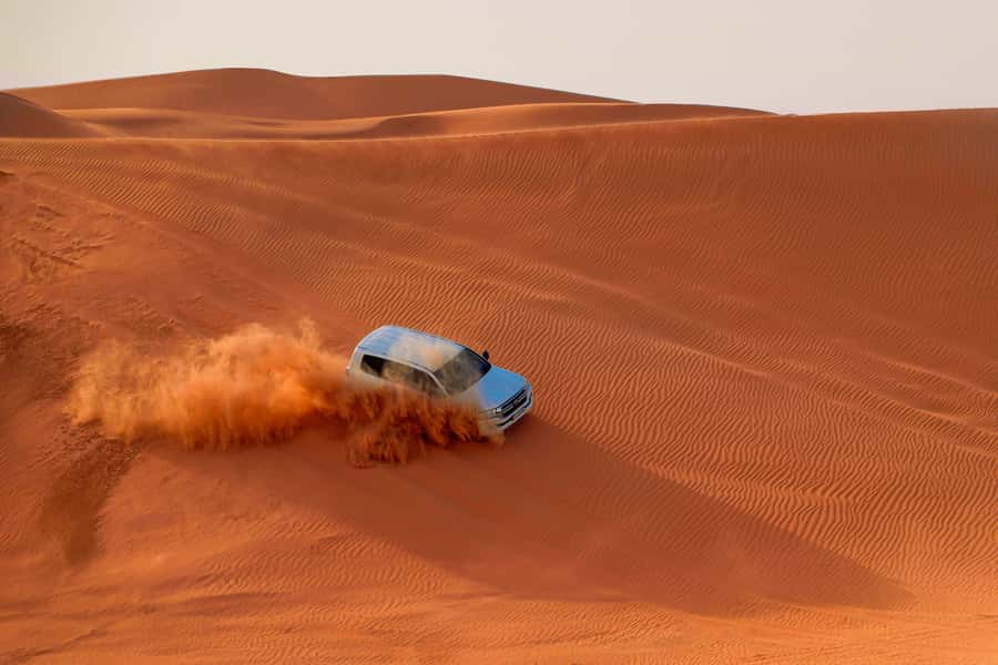Dubai: Desert Safari, Quad Bike, Sandboarding, Camels & BBQ - Dune bashing across the Lehbab sands