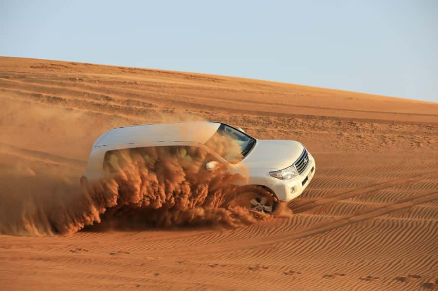 Dubai: Desert Safari, Quad Bike, Sandboarding, Camels & BBQ - BBQ dinner, Arabic sweets, and evening shows