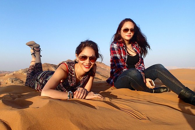 Dubai Desert Safari with BBQ Dinner, Camel Ride, and Shows - Sandboarding and the sunset stop
