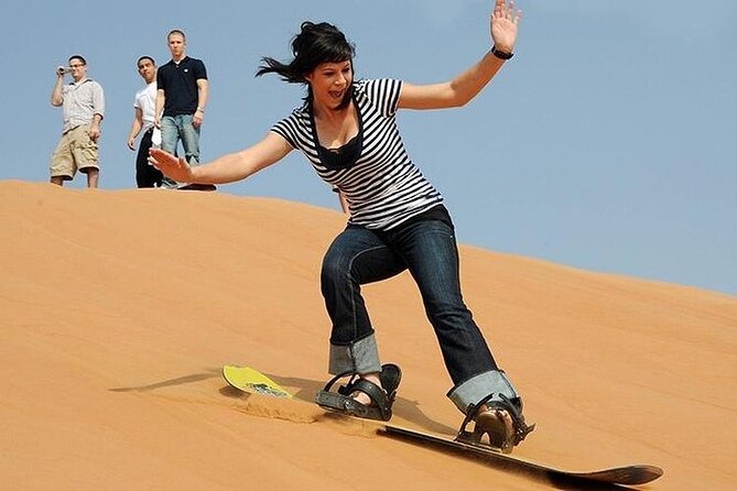 Dubai Desert Safari with BBQ Dinner in red sand - Sandboarding on the red dunes