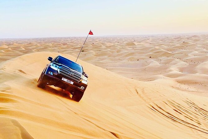 Dubai Desert Safari with BBQBuffet, Dune Bashing, Boarding, Camel - Sandboarding from a high dune