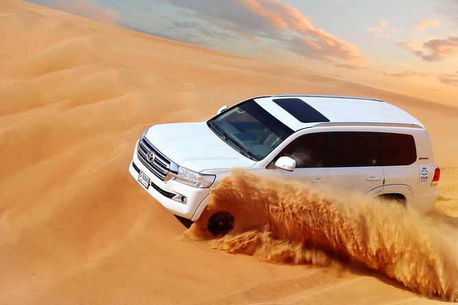Dubai Desert Safari with Desert Camp Dinner, Camel Ride & Shows - Dune bashing across the Dubai sand