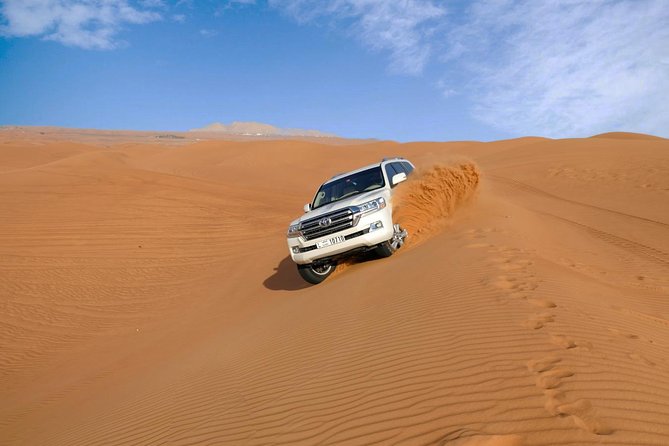 Dubai Desert Safari with Dune Bashing, Camel Rides & BBQ - Camp Life After Sunset