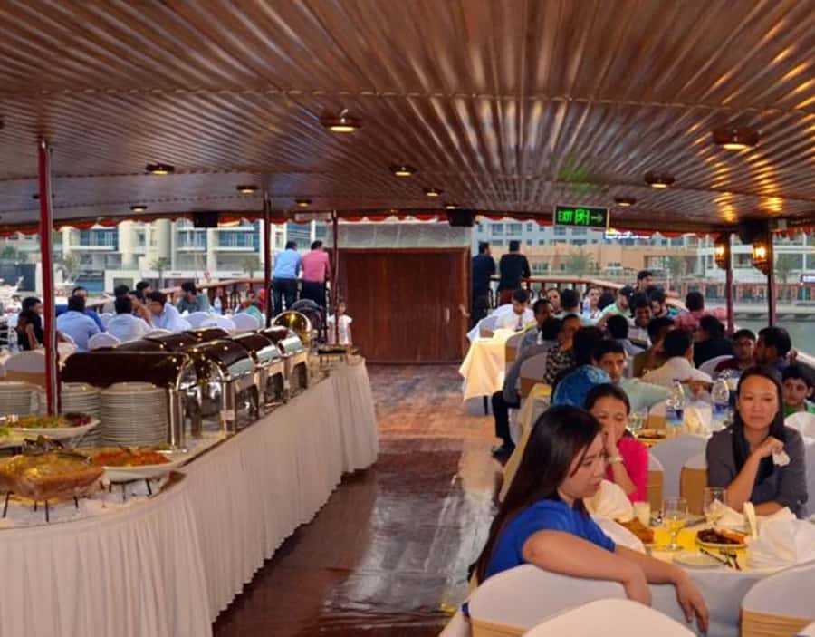 Dubai: Dhow Dinner Cruise on Creek or Marina with Live Shows - Boarding a traditional Arabian dhow