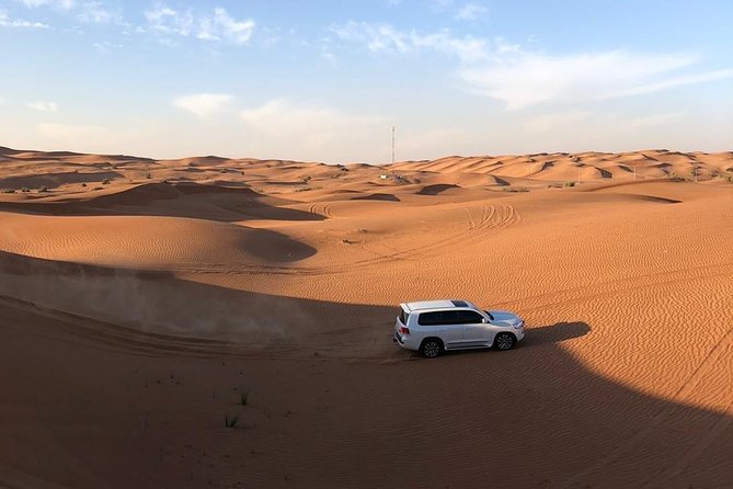 Dubai Evening Desert Safari with ATV Quad Bike & Dinner - Red dunes, sandboarding, and the sunset stop