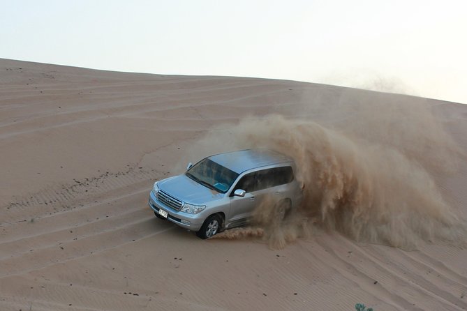 Dubai High Red Dunes Extreme Desert Safari Adventure with BBQ Dinner - Sandboarding and sunset photos at Al Badayer