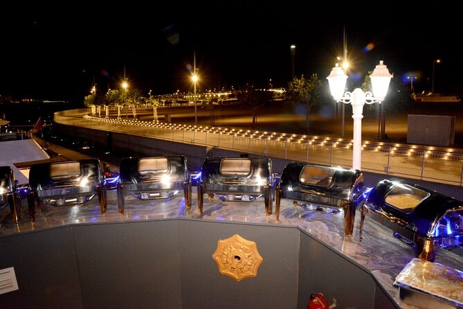 Dubai Marina Unique Dhow Cruise Buffet Dinner and Belly Dance - A wooden dhow with a modern Dubai backdrop