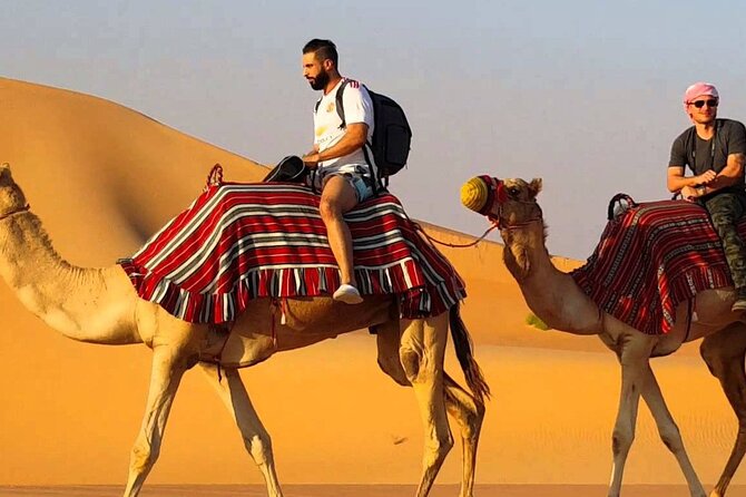 Dubai Premium Evening Desert Safari ATVs, Dinner & Shows - Sandboarding and sunset photos at Lahbab
