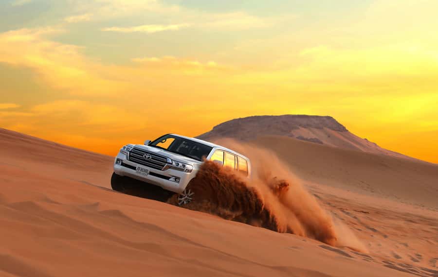 Dubai: Red Dune Desert Safari, Quad Bike, Camels, and BBQ - From Dubai hotels to the edge of the dunes
