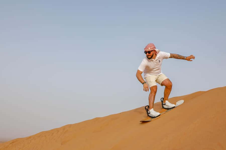Dubai: Red Dunes Quad Bike with Sandboarding, Camels and BBQ - Sandboarding and desert photo stops