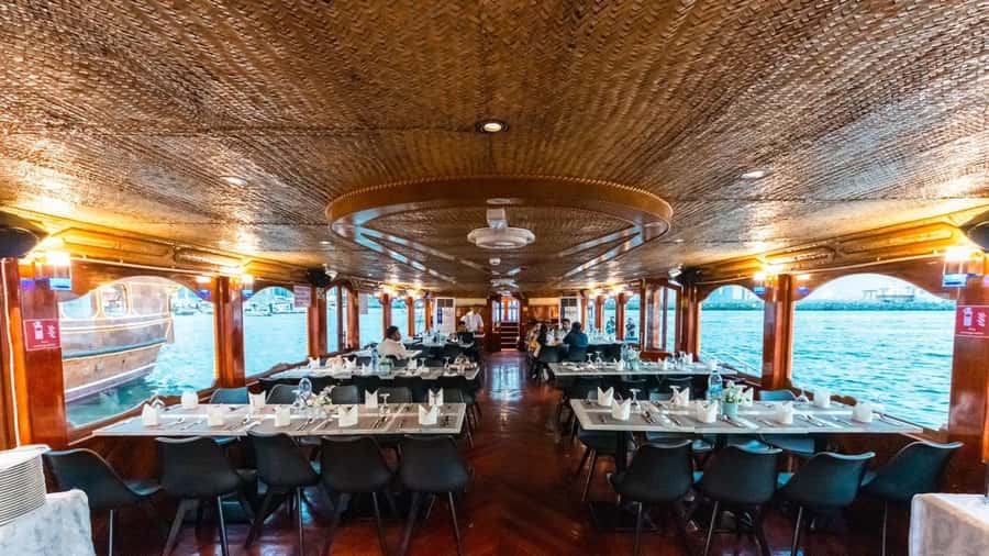 Dubai: Scenic Dhow Cruise with Buffet Dinner and Live Shows - Boarding a traditional dhow on Dubai Creek