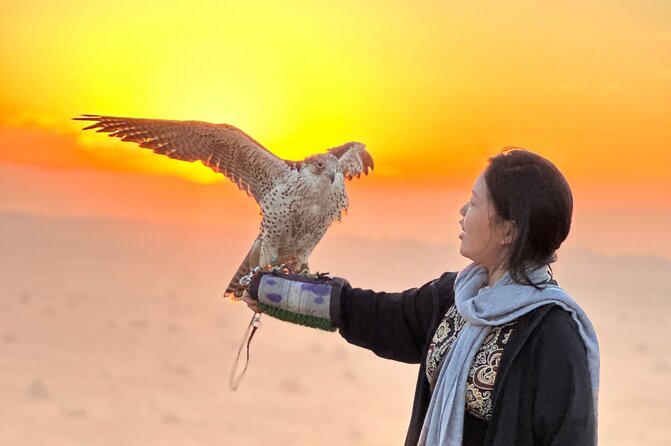 Dubai Sunset Red Dune Desert Safari, Sandboarding and Camel Ride - Sandboarding on a forgiving desert slope