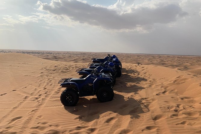 Dubai: Unique SUNSET Quad Bike Red Dunes Safari - A camel ride gives the desert a slower rhythm