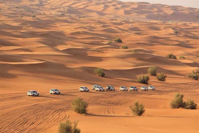 Evening Red Dunes Desert Safari: BBQ Dinner & Adventure Awaits! - Sandboarding and the sunset photo stop