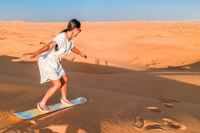 Red Dunes Desert Safari, Sand Board, Camel Ride with BBQ Dinner - Sandboarding on the red dunes